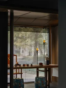 A serene tea room featuring wooden furniture and ceramic tea set