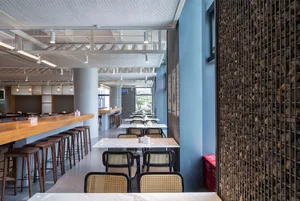 A modern cafe interior featuring minimalist design with concrete elements.