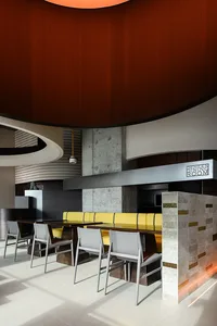 Modern restaurant interior with concrete, wood, and metal materials