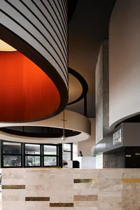 Modern restaurant interior featuring concrete and marble materials.