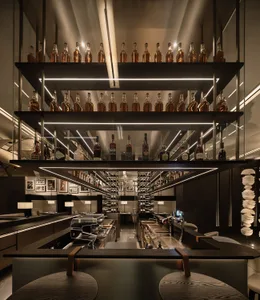 A well-lit, modern restaurant bar with electronic shelves displaying bottles.