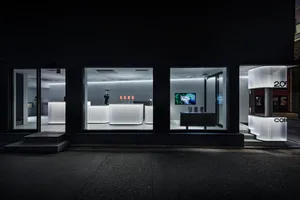 White concrete interior of a modern coffee shop showing sleek design elements.