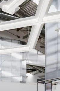 Industrial-style office space featuring glass, concrete, and metal elements