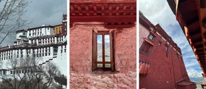 Red-walled Tibetan architectural structure with a window overlooking mountains.