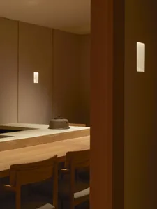 A minimalist restaurant interior featuring wood elements.