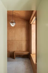 A minimalist wooden wardrobe with a modern design, featuring clean lines and warm wood tones.