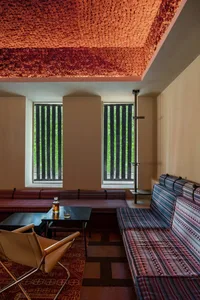 Modern hotel lounge with textured ceiling and concrete flooring.
