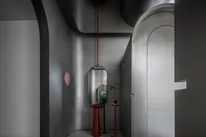 Minimalist industrial interior with metallic finishes and geometric shapes.
