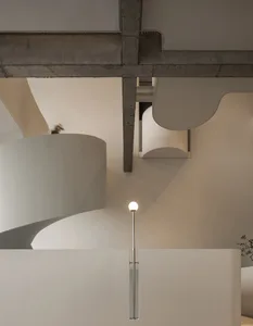 Contemporary residential interior with modern design, featuring concrete and metal materials and minimalist architectural ele