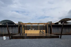 A construction site featuring modern architecture with a tarnished steel facade.
