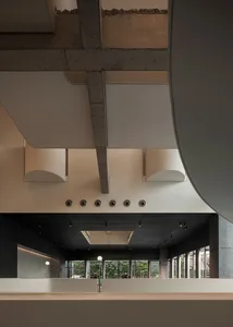 An image depicting a modern interior space with a concrete ceiling and exposed beams.