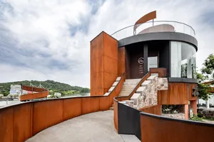 A modern restaurant with a unique, eye-catching exterior made of rust-colored metal.