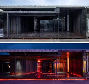 A metal interior space transitioning from dark to light, featuring contrast and illuminated paths.