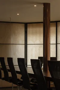 A modern office meeting room with a metallic support column.