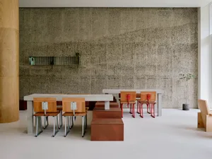 A modern office space featuring concrete walls and minimalist design.