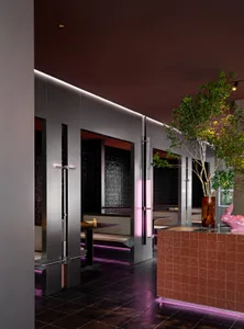 Modern, metallic, and wooden restaurant interior with glass elements.