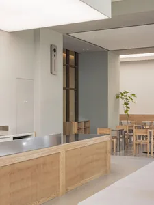 Modern cafeteria with wooden tables and metal chairs
