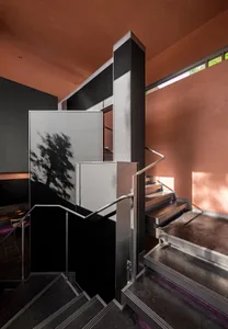 Modern interior space featuring metallic staircase with sleek design elements.