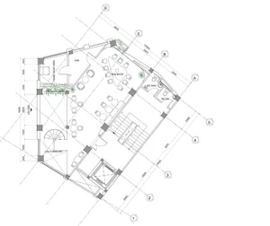 Industrial-style office layout with steel beams, concrete floor, and glass partitions.