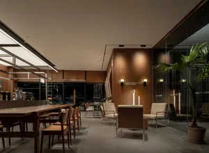 A modern coffee shop featuring industrial design elements and wooden materials.