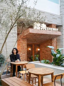 Industrial-style restaurant exterior with brick walls and white signage