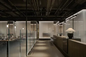 Industrial-themed restaurant featuring glass, steel, and wooden elements