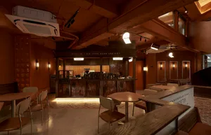 Interior of an industrial-themed restaurant with wooden tables and chairs.