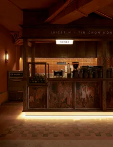 A modern coffee shop counter made of wood with a sign that says 'ORDER'.