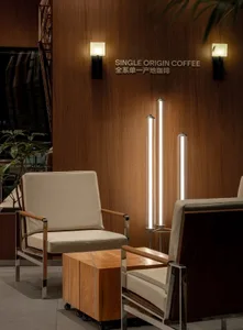 Modern coffee shop featuring wooden walls, leather seating, and single-origin coffee signage.