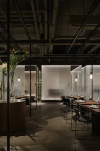 Interior design image of a modern restaurant featuring glass and concrete elements.