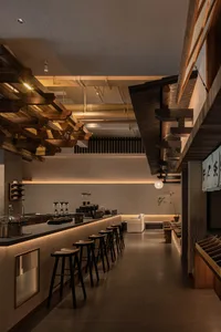 Modern interior design of a coffee shop bar with wooden and concrete surfaces.