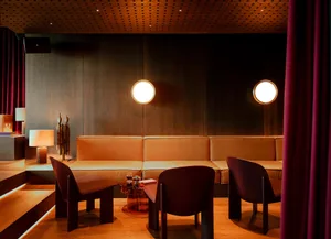 Modern hotel bar featuring luxurious leather curtains and contemporary design elements.