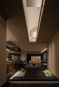 A modern residential interior featuring a mix of concrete and wooden materials.