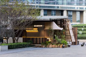 Modern restaurant exterior with wooden facade and glass windows.