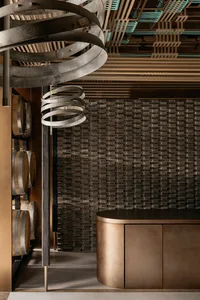 Industrial-style bar area with metallic elements and a textured wall.