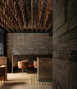 Modern minimalist restaurant interior featuring wooden elements and contemporary design.