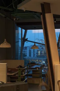 A modern restaurant interior featuring wooden and glass elements.