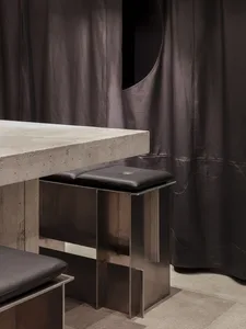 Concrete and metal dining counter in a minimalist restaurant interior