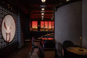 An elegant, modern bar with wooden decor, glass elements, and metal accents.