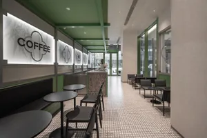 Interior design of a modern coffee shop featuring glass and steel materials.