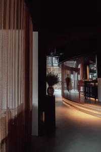A modern-looking restaurant interior with glass curtains and a cozy ambiance.