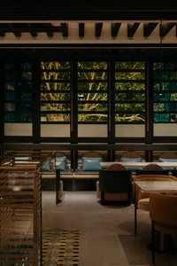 A modern restaurant interior featuring wood and leather materials.