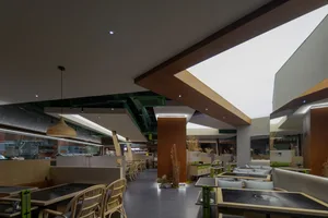 A modern restaurant with timber and concrete interior design elements.
