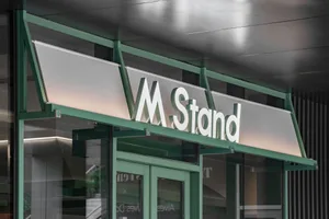 Modern retail storefront sign featuring metallic material