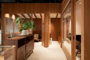 Modern exhibition space featuring wooden interior design and wearable art