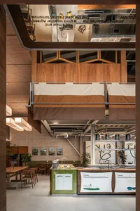 A modern industrial café with wooden countertops and a rustic ambiance, featuring a range of food and drink options.