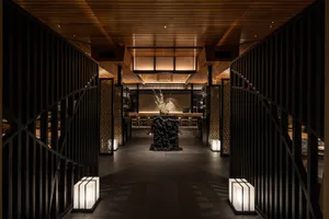 A modern restaurant interior featuring wooden materials and contemporary design elements.