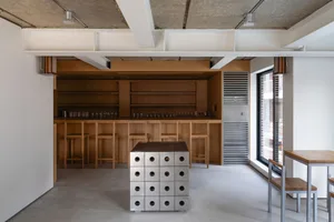 A minimalist coffee shop interior with a wooden counter and metallic accents.