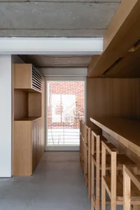 A minimalist interior design featuring wooden shelves and a concrete floor.
