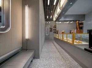 A contemporary bakery interior with modern design elements and concrete flooring.